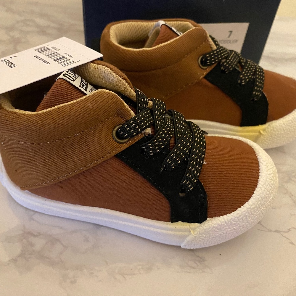 New with Tags. OshKosh B’gosh, high-top style sneakers. Size 7.